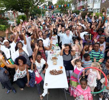 People waving at a street party